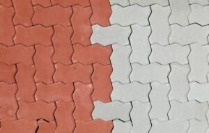 Close-up of a red and white brick retaining wall, showcasing the texture and pattern of the bricks.
