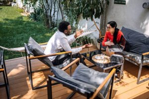 Two people engaged in conversation while sitting on a newly constructed patio.