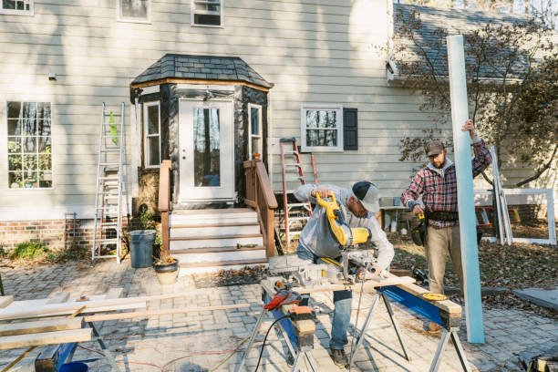 Two men working together on a wooden frame for patio construction.