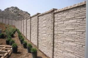 Decorative concrete wall adorned with potted plants, showcasing a blend of natural and architectural elements.
