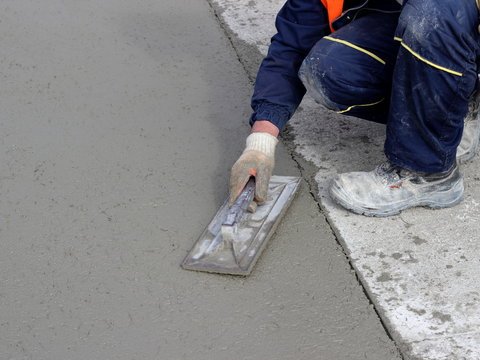 Affordable concrete contractors preparing and leveling cement for foundation work