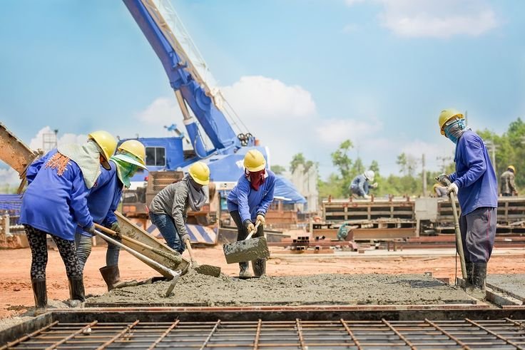 Concrete construction workers handling residential and commercial projects side by side


